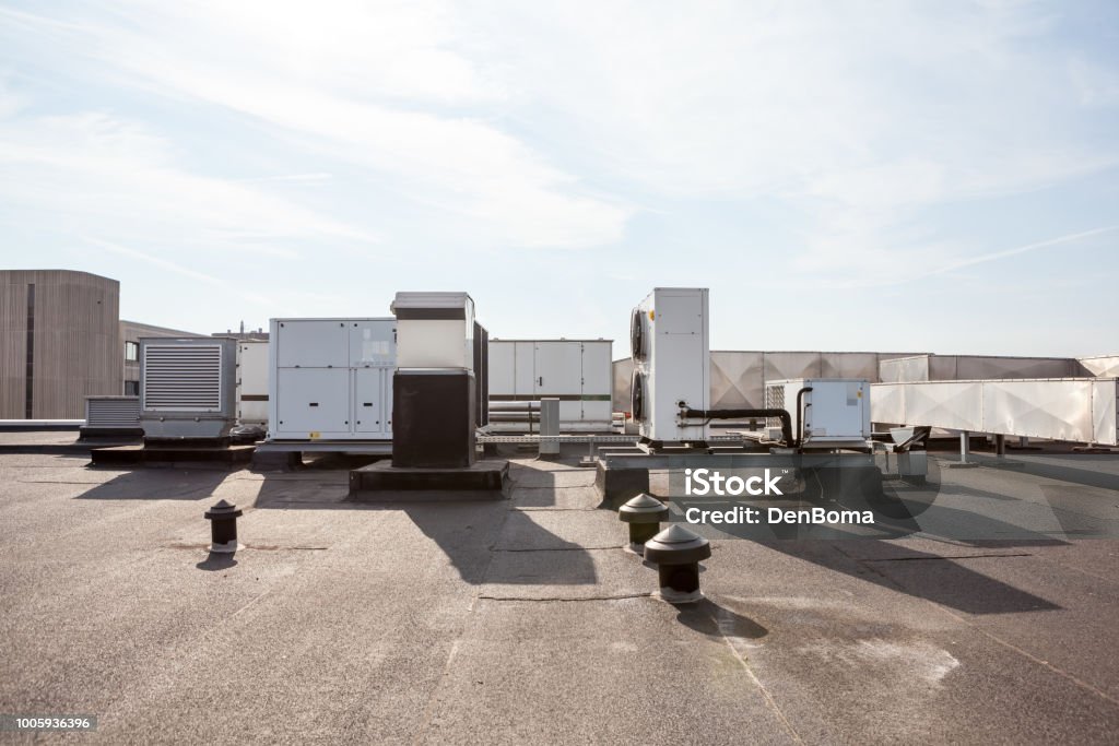air ducts on the roof ventilators on the roof of a tall building in the industrial area Rooftop Stock Photo