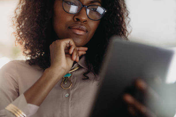 istock Businesswoman looking at tablet pc 1005938818