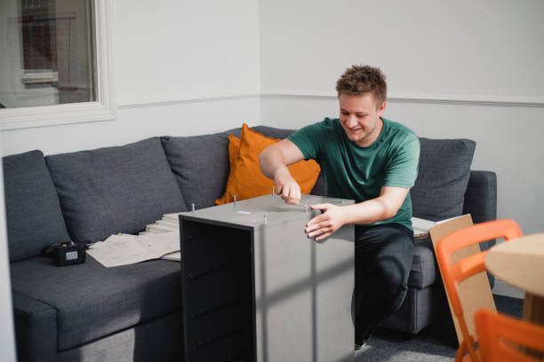 istock Young Man Putting Together Flat-Pack Furniture 1005938938
