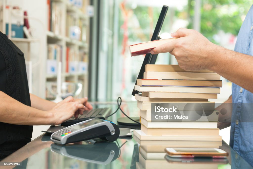 Customer buying books Book Stock Photo