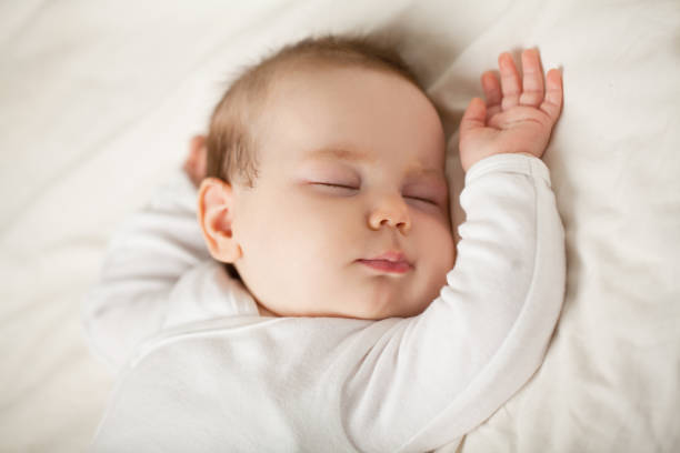 Sleeping newborn baby on white background. Small sleeping child, bedtime (baby up to one month) Sleeping newborn baby on white background. Small sleeping child, bedtime (baby up to one month) baby stock pictures, royalty-free photos & images