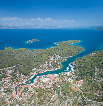 Unique aerial of the beautiful croatian harbor town Vrboska Otok located on the Island Hvar in the Adriatic Sea. Croatia. You can see the island Brac and the Main Land in back. Converted from RAW.