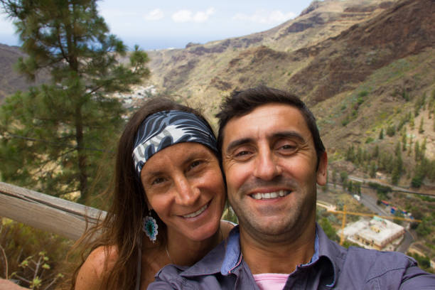 istock Smiling couple selfie at nature park view point 1005948662