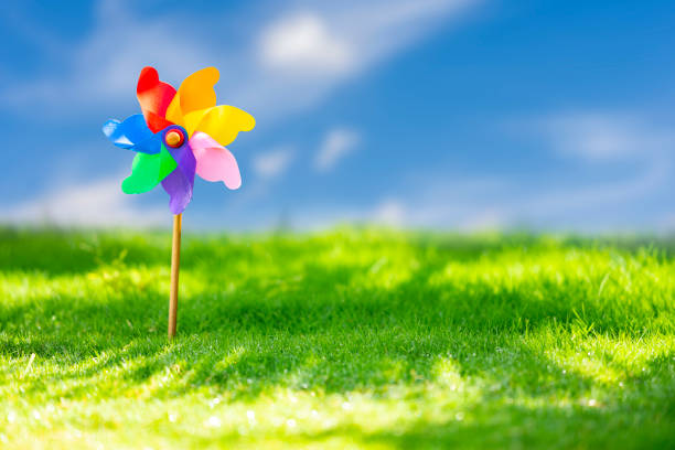 istock Pinwheels on Meadow at Sunny Day 1005949374