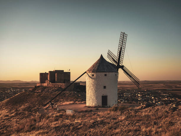 Ancient traditional windmills in Consuegra Toledo province Spain. Hundreds of those windmills where spread across La Mancha and they were the inspiration for the famous chapter of Don Quixote fighting the windmills thinking they were giants