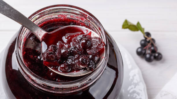 istock Jam from black chokeberry berries ( Aronia ) with apples. Homemade preserves. 1005952174