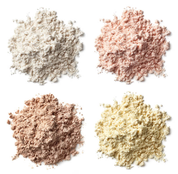 four various heaps of protein powder (vanilla, strawberry, chocolate, banana) - protein concentrate imagens e fotografias de stock