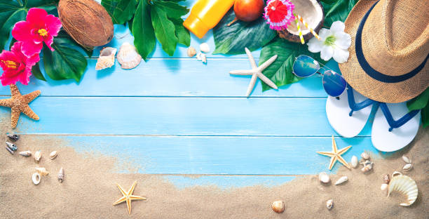 istock Straw hat with a exotic cocktail and sunglasses on sand beach 1005953104