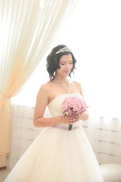 istock young bride with a bouquet of roses 1005955424