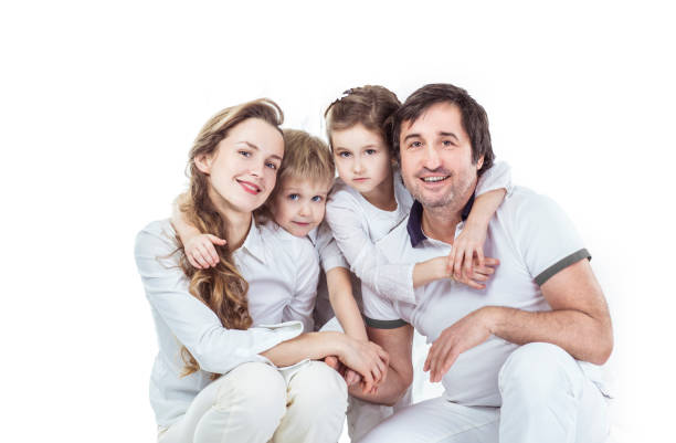 istock family portrait: parents with daughter and son on white background 1005956362