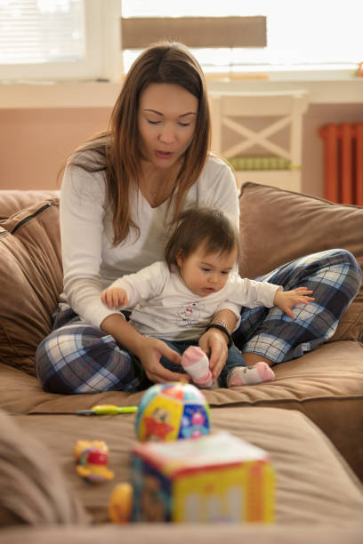 istock Baby and mom playing on the bed 1005961202