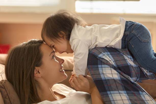 istock Baby and mom playing on the bed 1005961272