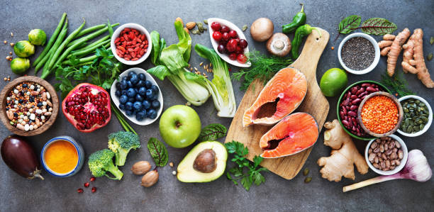 Healthy food selection Healthy food selection: food sources of omega 3 and unsaturated fats, fruits, vegetables, seeds, superfoods with high vitamin e and dietary fiber, cereals on gray background acid photos stock pictures, royalty-free photos & images