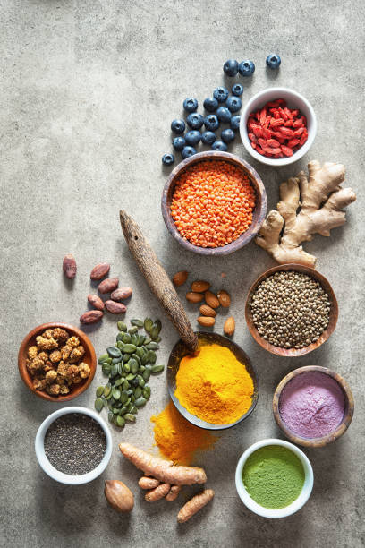 Various colorful superfoods in bowls Various colorful superfoods as acai powder, turmeric, matcha green tea, quinoa, pumpkin seeds, blueberry, dried goji berries, cape gooseberries, raw cocoa, hemp seeds and other in bowls antioxidant stock pictures, royalty-free photos & images