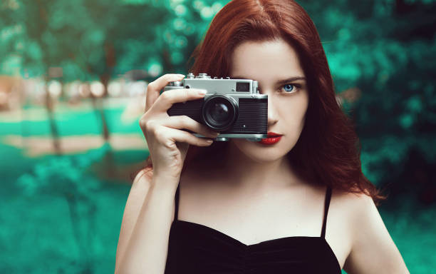 Young woman with retro camera