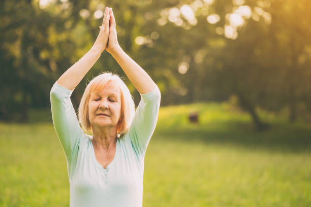 istock Sporty senior woman meditating 1005968212
