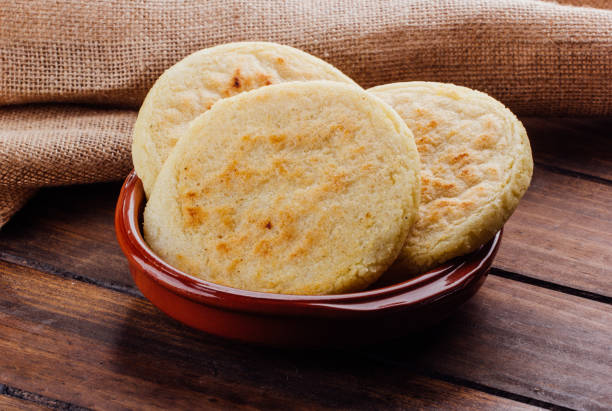 Plate with arepas on a rustic wooden background stock photo
