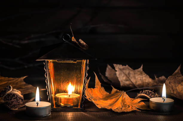 istock old lantern, autumn leaves on a wooden table 1005983862