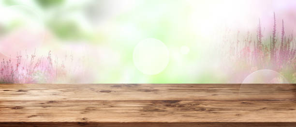 istock Tender floral background with wooden table 1005984360