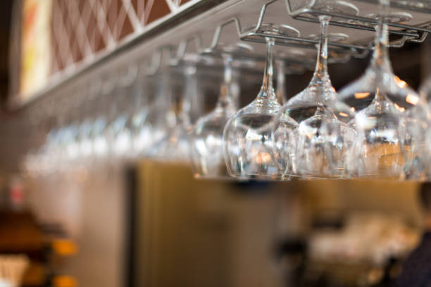 istock Selective focus of drinking glasses hanging in a row at outdoors bar 1005984712