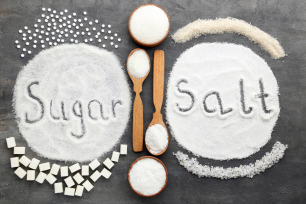 Inscription Sugar and Salt on grey wooden table stock photo