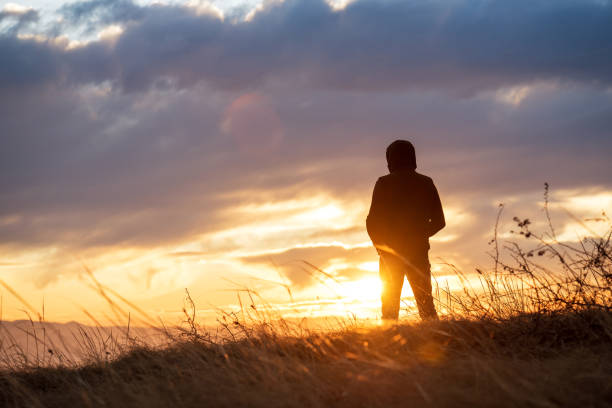 istock tourist in the mountains at sunset. 1005987450