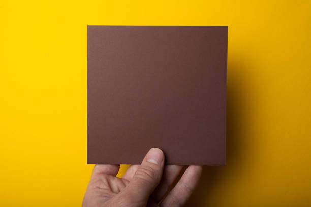 istock square white mocap in hand on a yellow background 1005988040