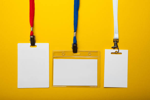 istock Empty set of ID badge isolated on yellow background 1005988050