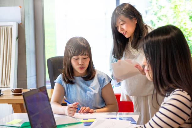 istock Asian Women Working Together at a Modern Coworking Space 1005988128
