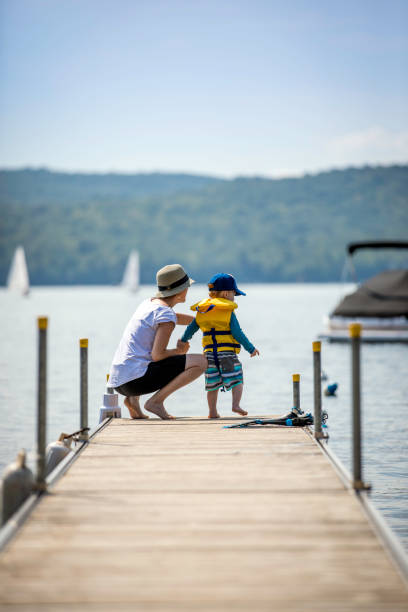 istock Mother and Son Looking at the View on Pier in Summer 1005991102