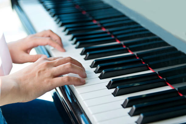 istock Woman hands playing piano 1005996048