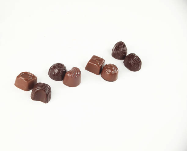 istock few chocolates isolated on white.photo with copy space 1005998268