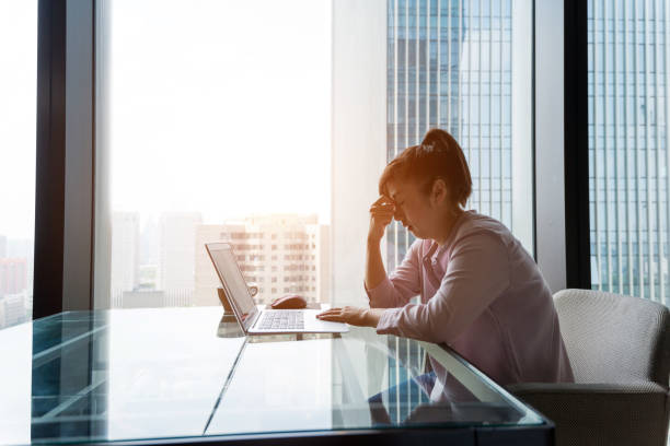 istock Woman having headache at workplace 1005999322