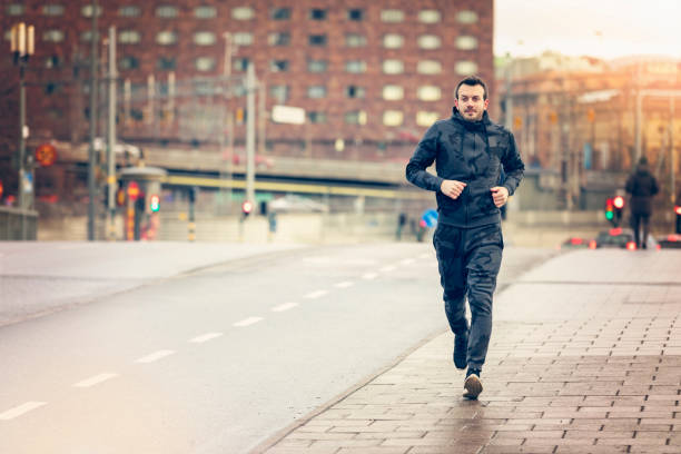 istock Handsome runner exercising by running and jogging in city 1006001802