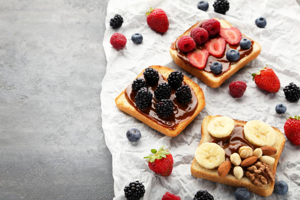 istock Toasts bread with berries on grey wooden table 1006001912
