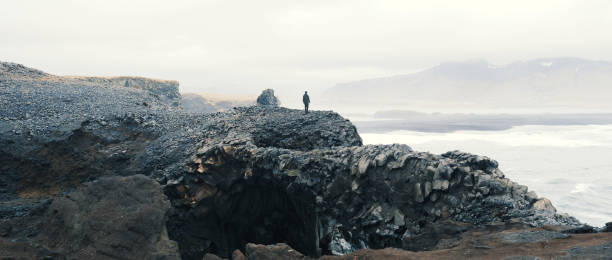 istock Woman overlooking scene at Vik, Iceland. 1006006070