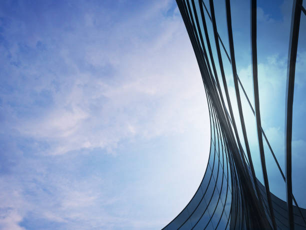 istock Perspective of high rise building and dark steel window system with clouds reflected on the glass.Business concept of future architecture,lookup to the angle of the building corner. 3d rendering 1006006546