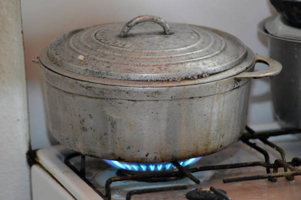 a dirty saucepan stands on a dirty gas stove in the kitchen at home, cooking soup on the stove, gas stove, kitchen