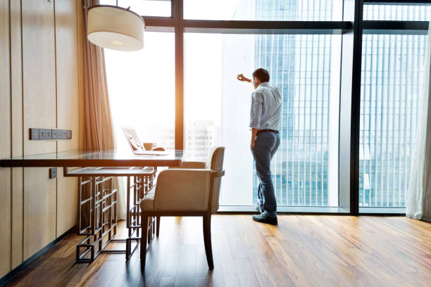 istock Tired businessman standing by the window 1006023008