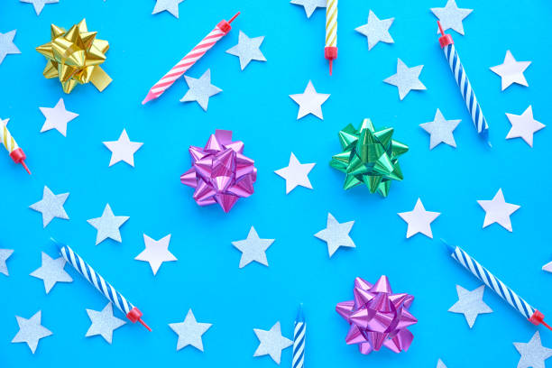 istock star sprinkles on blue. Festive holiday background. Celebration concept. Top view, flat lay. Horizontal 1006041412