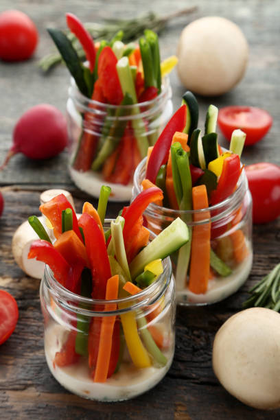 istock Sliced vegetables in glasses on wooden table 1006041980