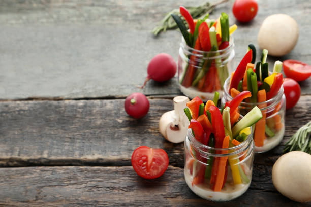 istock Sliced vegetables in glasses on wooden table 1006042368