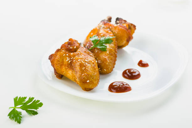 istock chicken wings with sesame on white background 1006045064