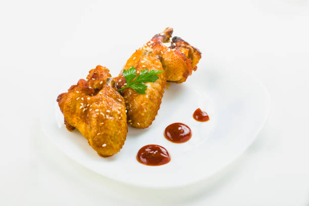 istock chicken wings with sesame on white background 1006045512