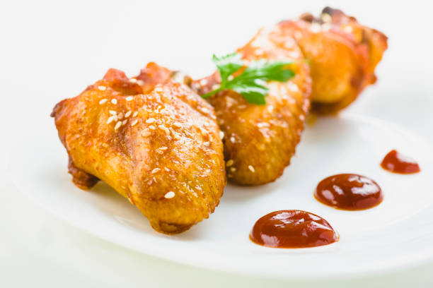 istock chicken wings with sesame on white background 1006045518