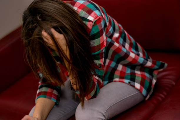 istock Young drunk woman sitting in the sofa 1006054032