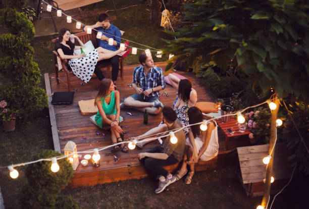 Garden party Group of pretty young people have a night party in a backyard garden parties stock pictures, royalty-free photos & images