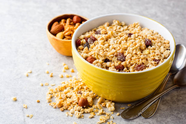 istock Granola and muesli in bowl on gray stone background 1006063762