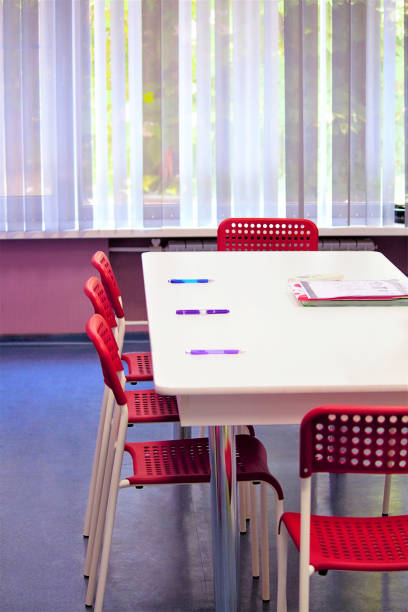 istock Office room, conference room or classroom. On a background of vertical curtains for a window with a closing mechanism. Selective focus, side view, copy space. 1006070822