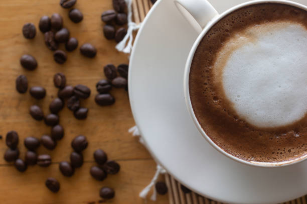 hot coffee in cup and coffee bean hot coffee in cup and coffee bean On the wooden table seramic stock pictures, royalty-free photos & images